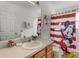 Bathroom featuring a Mickey Mouse-themed shower curtain and matching decor at 195 Hideaway Beach Ln, Kissimmee, FL 34746