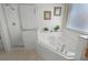 Bright bathroom with a corner bathtub, separate shower, and tiled walls for a clean and modern feel at 195 Hideaway Beach Ln, Kissimmee, FL 34746