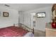 Bedroom featuring iron bed with a dresser and TV. Includes ensuite bathroom at 195 Hideaway Beach Ln, Kissimmee, FL 34746