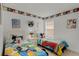 Bedroom featuring two twin beds with Mickey Mouse-themed bedding and decorative wall accents at 195 Hideaway Beach Ln, Kissimmee, FL 34746
