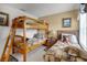 Shared bedroom featuring a bunk bed, a single bed and themed wall decorations at 195 Hideaway Beach Ln, Kissimmee, FL 34746