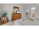 Bright bedroom featuring a dresser with an arched mirror and an adjacent bathroom at 195 Hideaway Beach Ln, Kissimmee, FL 34746