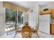 Cozy breakfast nook with sliding glass doors that lead to a screened patio and pool area, offering a casual dining space at 195 Hideaway Beach Ln, Kissimmee, FL 34746
