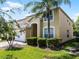 Beautiful two-story home with lush landscaping, attached garage, and a well-manicured lawn at 195 Hideaway Beach Ln, Kissimmee, FL 34746