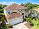 Aerial view of a well-maintained two-story house with a driveway and landscaped yard at 195 Hideaway Beach Ln, Kissimmee, FL 34746