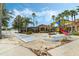 Community playground featuring a covered picnic area, shuffleboard, and play equipment at 195 Hideaway Beach Ln, Kissimmee, FL 34746