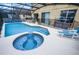 Inviting backyard pool with integrated spa, lounge chairs, and protective fence, ideal for Gathering enjoyment at 195 Hideaway Beach Ln, Kissimmee, FL 34746