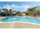 Large community pool surrounded by palm trees, lounge chairs, and an expansive sun deck at 195 Hideaway Beach Ln, Kissimmee, FL 34746