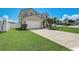 Two story home featuring a manicured front lawn, concrete driveway and a two car garage at 2024 Bearing Ln, Kissimmee, FL 34744