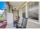 Comfortable front porch featuring rocking chairs, stylish columns, and decorative planters at 2024 Bearing Ln, Kissimmee, FL 34744