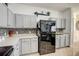 Modern kitchen featuring gray cabinets, granite countertops, and stainless steel refrigerator at 2024 Bearing Ln, Kissimmee, FL 34744