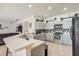Bright eat-in kitchen featuring gray cabinets, stainless steel appliances, and tiled floors at 2024 Bearing Ln, Kissimmee, FL 34744