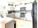 Modern kitchen with stainless steel appliances, tiled backsplash, and ample counter space at 2024 Bearing Ln, Kissimmee, FL 34744