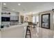 Modern kitchen featuring an open layout to the dining area, gray cabinets and barstool seating at 2024 Bearing Ln, Kissimmee, FL 34744