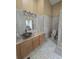 Bathroom with tile and cabinets showing commode and shower area at 204 Canary Island Cir, Davenport, FL 33837