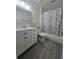 Bathroom with white vanity, chrome fixtures, and marble shower curtain at 204 Canary Island Cir, Davenport, FL 33837