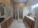 Bathroom showing dual vanities with shower and commode areas between them at 204 Canary Island Cir, Davenport, FL 33837