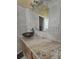 Bathroom vanity with granite countertops and a dark vessel sink under an accent mirror at 204 Canary Island Cir, Davenport, FL 33837
