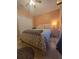 Comfortable bedroom with a double bed, tile floors, closet and side table with a lamp at 204 Canary Island Cir, Davenport, FL 33837