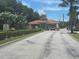 Gated community entrance with stone accents, lush landscaping, and a secure entry point for residents and guests at 204 Canary Island Cir, Davenport, FL 33837