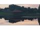 Picturesque gazebo on a tranquil lake, its reflection mirroring the peaceful surroundings, ideal for relaxation and contemplation at 204 Canary Island Cir, Davenport, FL 33837