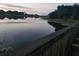 Scenic lake view from a wooden pier, reflecting a serene and peaceful atmosphere at twilight, perfect for relaxation at 204 Canary Island Cir, Davenport, FL 33837