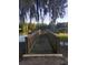 Wooden dock extending over a calm lake, offering a serene spot for relaxation and enjoying nature's beauty at 204 Canary Island Cir, Davenport, FL 33837