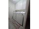 Laundry room with white cabinets above the washer and dryer on a tile floor at 204 Canary Island Cir, Davenport, FL 33837