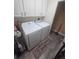 White laundry machines with cabinets above in a well-lit room on a tile floor at 204 Canary Island Cir, Davenport, FL 33837