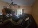 Cozy living room with leather sofa, ceiling fan, and wood-look flooring at 204 Canary Island Cir, Davenport, FL 33837