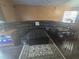 Living area featuring a large leather sectional, area rug and wood-look floors at 204 Canary Island Cir, Davenport, FL 33837
