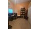 A home office features tile flooring, a computer desk, storage cabinet, and a window with blinds at 204 Canary Island Cir, Davenport, FL 33837