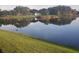 Scenic pond view with home reflections and lush green lawns in a tranquil and picturesque setting at 204 Canary Island Cir, Davenport, FL 33837
