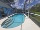 A bright blue pool in a screened enclosure, along the back of the house at 204 Canary Island Cir, Davenport, FL 33837