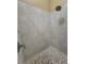 Walk-in shower with tiled walls and a decorative tile floor, and a chrome shower head at 204 Canary Island Cir, Davenport, FL 33837
