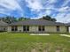 View of the backyard with a well-maintained lawn and a sunny sky at 2141 Fawn Meadow Cir, St Cloud, FL 34772