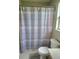 Bathroom features a shower-tub combo and honeycomb patterned curtain at 2141 Fawn Meadow Cir, St Cloud, FL 34772