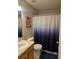 Bathroom with sink and a shower/tub with a patterned blue shower curtain at 2141 Fawn Meadow Cir, St Cloud, FL 34772