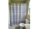 Bathroom features a shower-tub combo and honeycomb patterned curtain at 2141 Fawn Meadow Cir, St Cloud, FL 34772