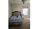 Bedroom with a bed, nightstand, window, and carpet flooring at 2141 Fawn Meadow Cir, St Cloud, FL 34772