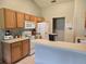 Bright kitchen featuring white appliances, light wood cabinets, and an extended counter space, perfect for casual dining at 2141 Fawn Meadow Cir, St Cloud, FL 34772