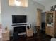 Contemporary living area featuring an electric fireplace, a large screen TV, and modern furniture, offering a cozy and stylish space at 2141 Fawn Meadow Cir, St Cloud, FL 34772