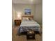 Serene bedroom with a comfortable bed, matching nightstand and a charming seascape painting, creating a relaxing retreat at 2141 Fawn Meadow Cir, St Cloud, FL 34772