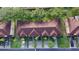 Aerial view of townhomes showcasing a well-maintained roof, landscaping, and ample parking spaces with several vehicles parked at 226 Verona Ave, Davenport, FL 33897