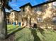 Exterior view of back of townhome featuring green lawn and air conditioning unit at 226 Verona Ave, Davenport, FL 33897