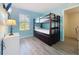 Cozy bedroom with bunk beds, blue walls, and wood-look flooring at 226 Verona Ave, Davenport, FL 33897