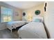 Bright bedroom with two twin beds, window, and green floral accents at 226 Verona Ave, Davenport, FL 33897