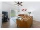 Cozy living room featuring tan leather couches, tile flooring, and sliding glass doors at 226 Verona Ave, Davenport, FL 33897