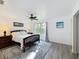 Serene main bedroom featuring wood-look floors, a ceiling fan, and abundant natural light at 226 Verona Ave, Davenport, FL 33897
