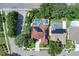 An aerial view of the property showcasing its pool, solar panels, and proximity to neighborhood streets at 2402 Raven Croft Ct, Orlando, FL 32837